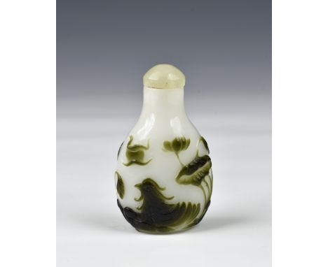 A Chinese carved cameo glass snuff bottle, of flattened pear form, the dark spinach green and white opaque glass finely carve