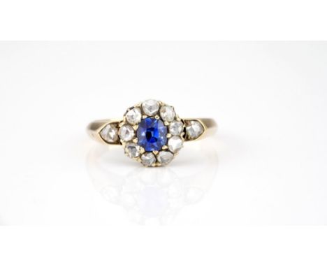 An antique 15ct yellow gold, sapphire and diamond cluster ring, late Victorian / Edwardian, the central oval cut sapphire wit