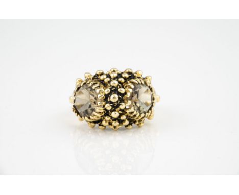 A vintage 14ct yellow gold and smoky quartz ring, 1960s-70s, the bombé, beaded ring set with two oval cut smoky quartz, size 