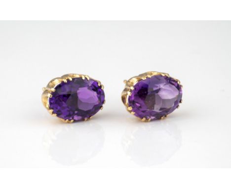 A pair of 9ct gold and amethyst stud earrings, the 13 x 9mm. oval cut amethysts in a crown setting. (2) 