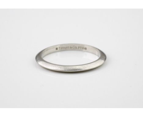 A Tiffany platinum wedding ring, marked 'Tiffany &amp; Co. PT 950', London 2008, size L, with bladed shank, in original box.