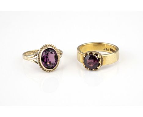 A Victorian 18ct gold and amethyst ring, the cushion cut amethyst claw set over a wide, plain band, size M; together with a 9