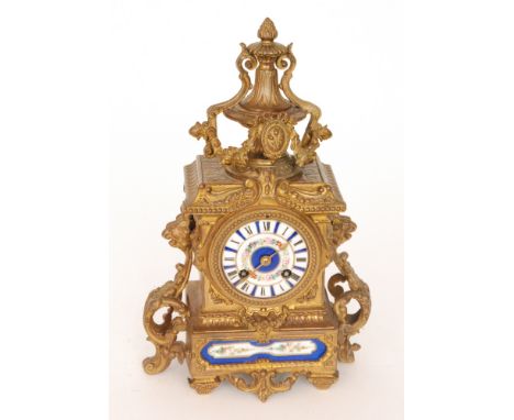 A 19th Century French gilt mantle clock with blue floral enamelled dial below and urn pediment, height 12cm