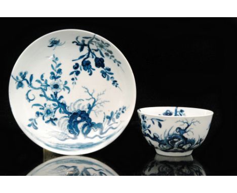 A late 18th Century Worcester blue and white teabowl decorated in the Prunus Root pattern, both with crescent marks, saucer d