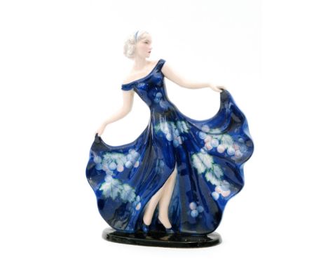 A 1930s Art Deco Goldscheider figure modelled by Claire Weiss as a lady dressed in a blue floral dress with holding her skirt