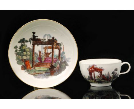 A late 18th Century Worcester teacup and saucer transfer decorated and hand enamelled with a scene of ruins with figures in t