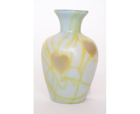 A 1985 Lundberg Studios glass vase of inverted baluster form, the iridescent opal ground decorated with amber hearts over pal