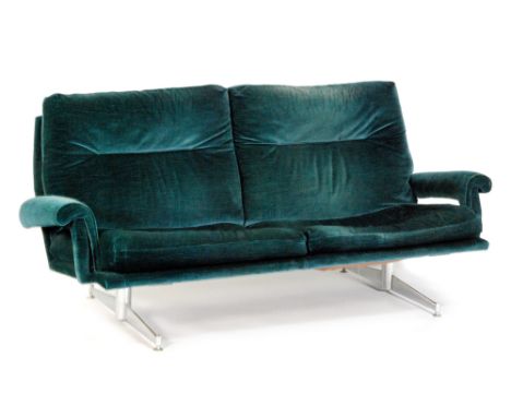 A post war two seat sofa by Howard Keith for HK Furniture, with blue velour upholstery above the chromium plated flattened st