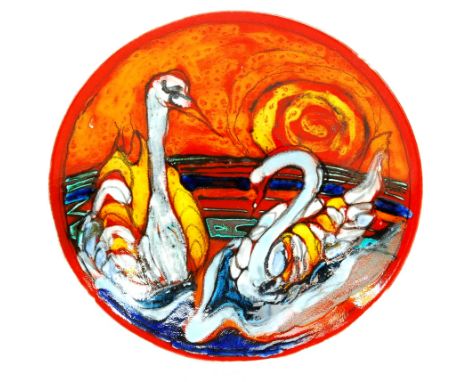 A large Poole Pottery shape 54 charger decorated with two large swans against a sunset sky, decorated with brightly coloured 