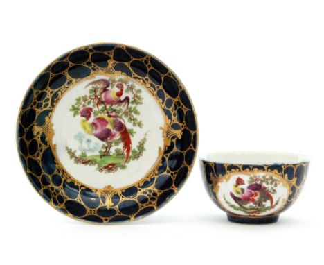 A late 18th Century Worcester teabowl and saucer decorated in the Fancy Birds pattern with cartouche panels decorated with en