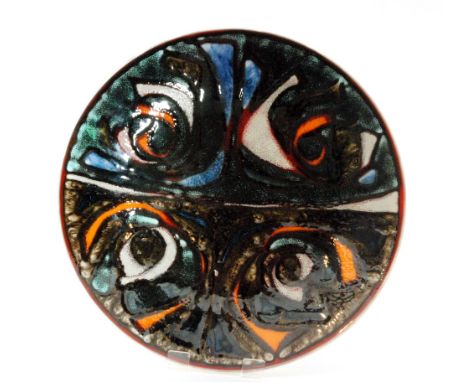 A large Poole Pottery Delphis shape 5 charger decorated by Patricia Wells with a segmented design in brightly coloured glazes
