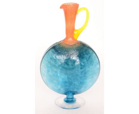 A later 20th Century Kosta Boda Bon Bon range jug by Kjell Engman with a clear crystal circular foot rising to a moon flask b