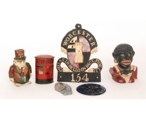 A replica cast iron Dinah money box and another of Kruger, together with a George VI tinplated oval money box and three repli