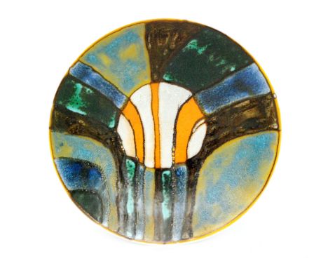 A Poole Pottery charger decorated by Patricia Wells with an abstract design in oxide glazes with a central orange and grey ro
