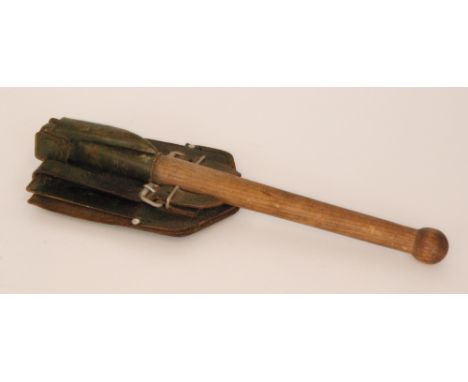 A mid 20th Century military folding pick axe and spade combination, terminating in a turned oak handle, impressed marks, leng