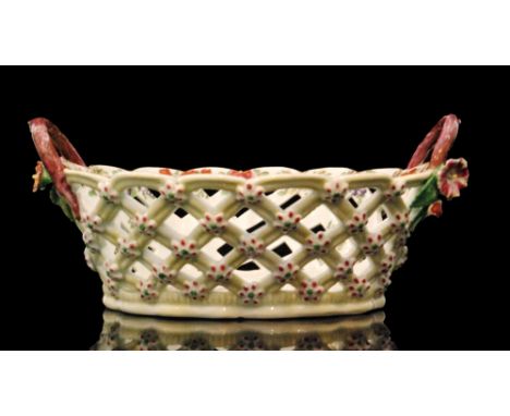 A late 18th to early 19th Century Worcester oval dessert basket with diamond diaper pierced sides, the exterior in a pale yel