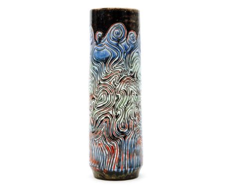 A Poole Pottery shape 85 Delphis cylindrical vase decorated with a carved linear design glazed in green, blue, red and brown,