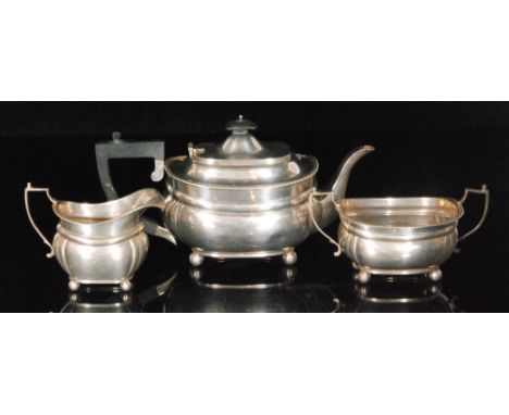 A George VI hallmarked silver three piece tea service with gadrooned rim on four ball feet, weight 39oz, London 1935, Thomas 
