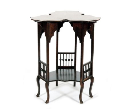 An Arts and Crafts occasional table of scalloped trefoil form, with bobbin turned supports united by a stretcher shelf, diame