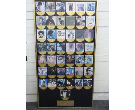 Bob Dylan - A framed presentation (approximately 80 x 150) to Mojo competition winner featuring 43 CD size cover photos with 