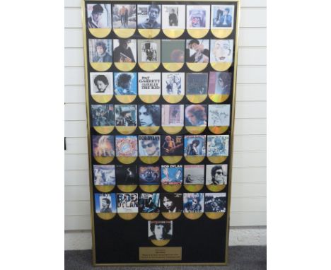 Bob Dylan - A framed presentation (approximately 80 x 150) to Mojo competition winner featuring 43 CD size cover photos with 