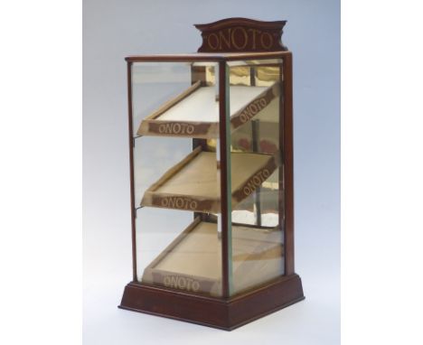 Onoto Pens glazed shop display cabinet with three inclined shelves behind bevelled glass panels and with Onoto to shelf front