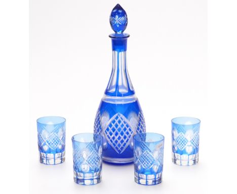 Flash overlaid cut glass drinking set comprising a decanter and four cups with blue overlay over a clear ground, decanter 36c