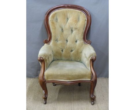 19thC mahogany button-back upholstered armchair with scrolling arms, raised on cabriole legs and ceramic castors
