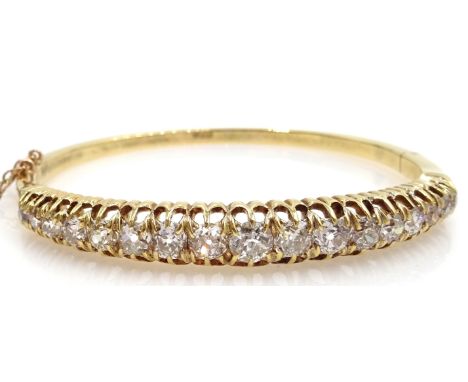 18ct gold seventeen stone graduating old cut diamond hinged bangle, diamonds approx 3.5 carats, centre stone approx 0.5 carat