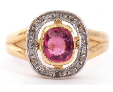 Ruby and diamond cluster ring, the bezel set cushion cut pale ruby within a small diamond surround, between pierced shoulders