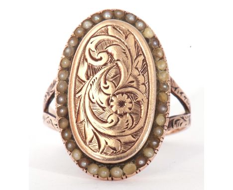 Antique yellow metal and pearl set ring, the oval panel engraved and chased with flowers and foliage, with a small seed pearl