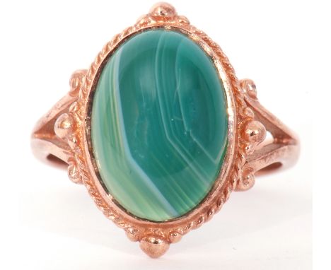 Modern 9ct gold and green quartz ring, centring a cabochon green quartz stone raised in a bezel mount and rope twist frame, s