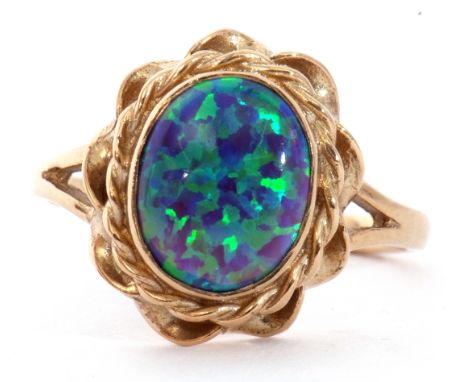 Modern 9ct gold and opalescent ring, the oval cabochon bezel set in a rope twist and pierced shoulder mount, size L