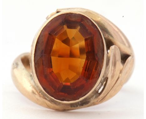 9ct stamped cognac citrine dress ring, the oval faceted citrine in a rub-over setting raised between cross-over shoulders, si