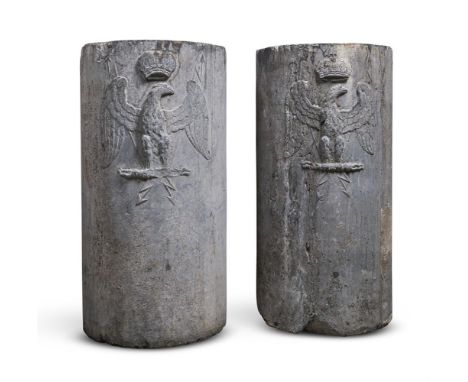 
	
		A PAIR OF FRENCH CARVED GREY STONE CYLINDRICAL PEDESTALS 
		18TH OR 19TH CENTURY 
		Each relief carved with a crowned ea