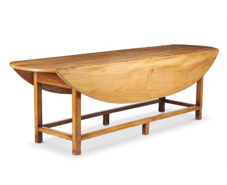 
	
		A MODERN ELM WAKE TABLE
		SUPPLIED BY CORYNDON
		The top with hinged sides, on square legs united by stretchers
		74cm h