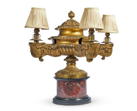 
	
		A WILLIAM IV BRASS COLZA LAMP IN THE MANNER OF MESSENGER 
		CIRCA 1830 
		with three branches issuing from a gadrooned a