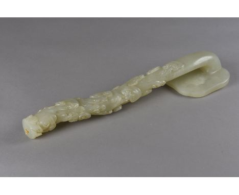 A late 19th Century Chinese green hardstone sceptre, the naturalistic carved staff supporting a scroll carved panel, 40.5 cm 
