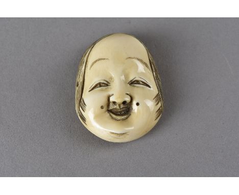 A Meiji period signed Japanese signed ivory netsuke, modelled as a female noh theatre mask, depicted with smiling face and di