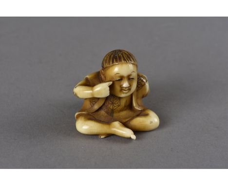 A Meiji period Japanese ivory carved netsuke, modelled as a seated boy with one hand raised towards his eye, the other hand b