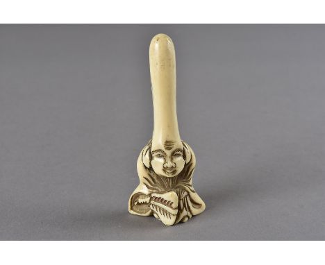 A Meiji period Japanese ivory netsuke, modelled as Jurojin seated holding a fan with elongated forehead, 6.6 cm x 2.7 cm 