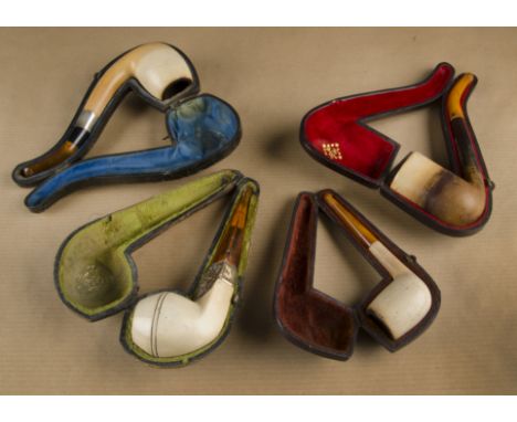 A cased meerschaum pipe, of brasenose shape with ornate gilt metal collar depicting horses and carriage on amber stem togethe