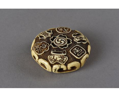 A Meiji period signed Japanese ivory ryusa netsuke, of circular design with pierced decoration of scrolls, vases, mons etc, s