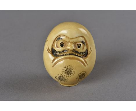 A late 18th/early 19th Century Japanese signed ivory netsuke, modelled as a duarma with protruding eyes and bearded face, flo