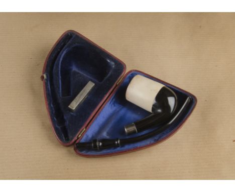A cased meerschaum and vulcanite pipe, the plain meerschaum bowl having hand cut fitted stem with white metal miniature vesta