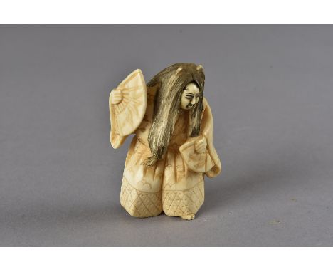 A Meiji period Japanese signed ivory netsuke, modelled as a Noh theatre dancer with two fans and revolving mask face, signed 