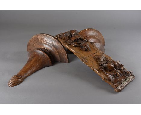 A Black Forest carved book trough, with bas relief flowers and berries, slide mechanism and brass hinges 38.5 cm L; together 