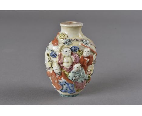 A Chinese porcelain snuff bottles, with relief 'Hundred Boys' decoration, seal marks to the base 7 cm H 