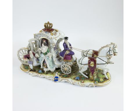 A royal horse-drawn carriage of hand-painted polychrome porcelain, with gilded crown and elegant figures with lace porcelain 