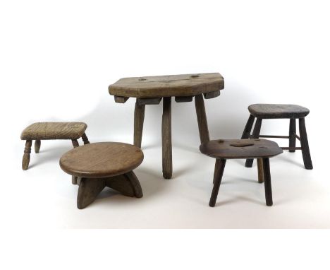 Five 19th century and later country made stools, comprising an oak stool with tripod base, 38 by 28 by 30.5cm high, together 